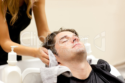 Positive caucasian man shampooed