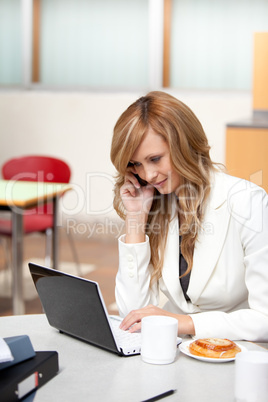 Busy businesswoman with laptop