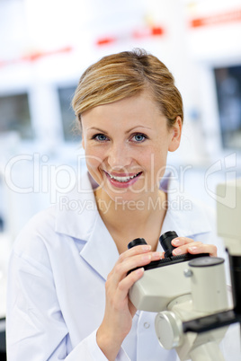 female scientist using a microscope