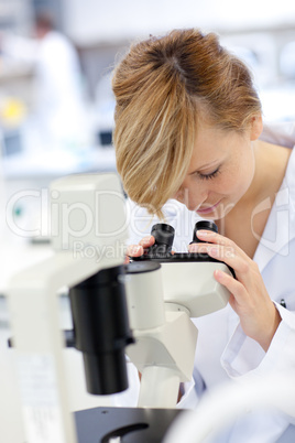 female scientist using a microscope