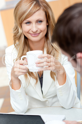 businesswoman holding a cup of coffee