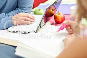 Close-up of two serious teenagers studying