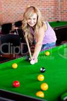 Bright woman playing pool