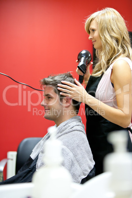 hairdresser drying her customer's hair
