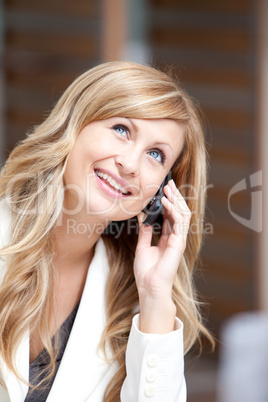 Positive businesswoman talking on phone