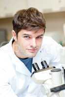 male scientist using a microscope