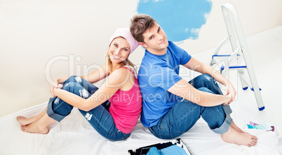 couple relaxing after painting a room
