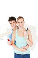Cheerful couple painting a room