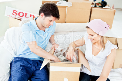 couple unpacking boxes