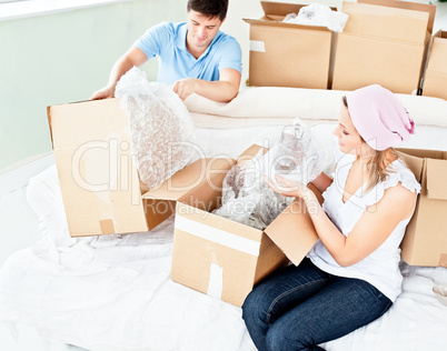 couple unpacking boxes