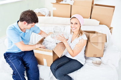 couple unpacking boxes