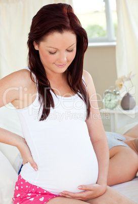 pregnant woman touching her belly