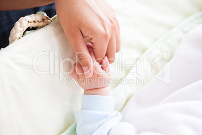 mother holding her baby's hand
