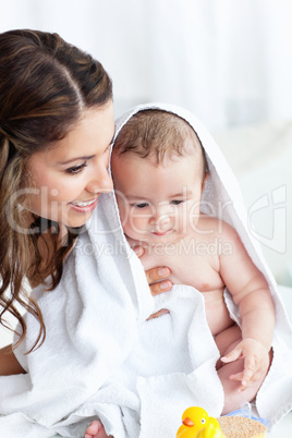 mother drying her baby after his bath