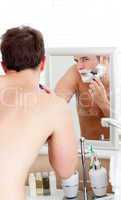 man shaving in the bathroom