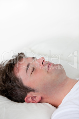 man sleeping on his bed