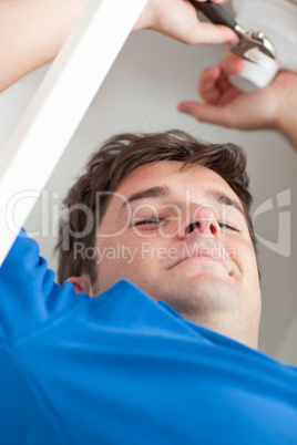 man repairing his sink in the kitchen