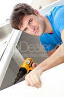 man repairing his sink
