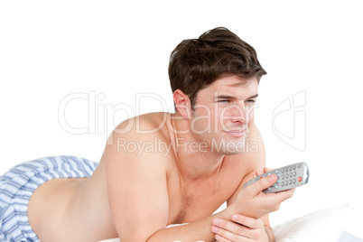 man holding a remote on his bed