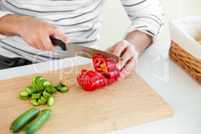 man cutting vegetables in the kitchen