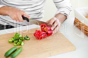man cutting vegetables in the kitchen