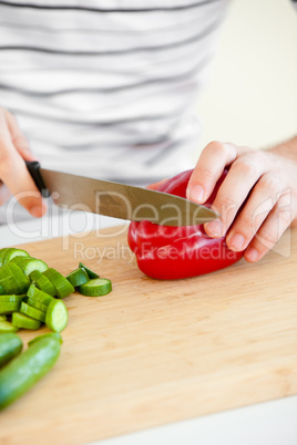 man cutting vegetables in the kitchen