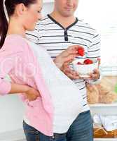 pregnant woman eating strawberries