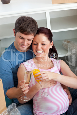 couple expecting a baby drinking