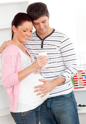 pregnant woman holding a glass of milk