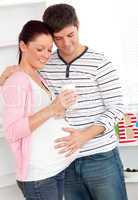 pregnant woman holding a glass of milk