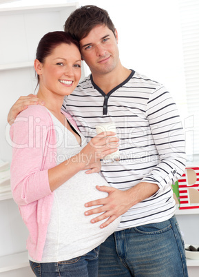 pregnant woman holding a glass of milk