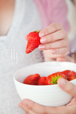 pregnant woman eating strawberries