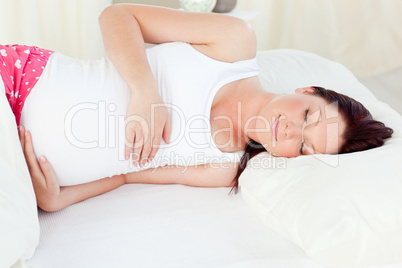 pregnant woman sleeping in her bed