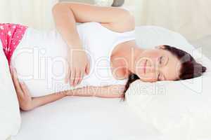 pregnant woman sleeping in her bed