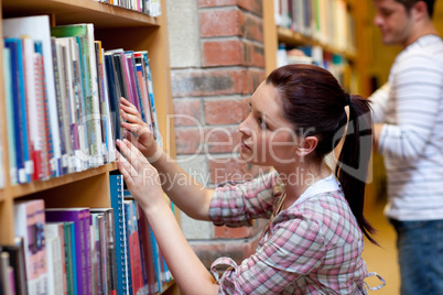 woman looking for a book
