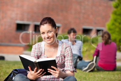 female student reading a book