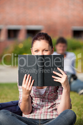 female student reading a book