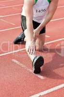 Male sprinter warming up