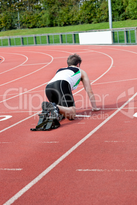 Athletic man waiting in starting block