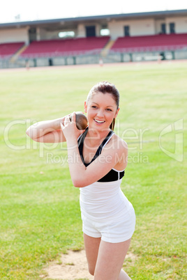 Attractive female athlete holding weight