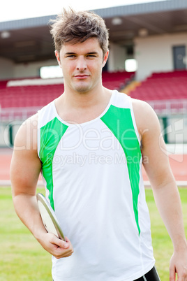 Portrait of a male athlete holding a discus