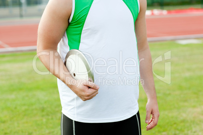 Close-up of a male athlete holding a discus