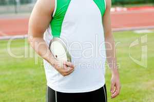 Close-up of a male athlete holding a discus