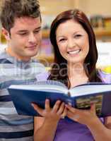 couple of students reading a book