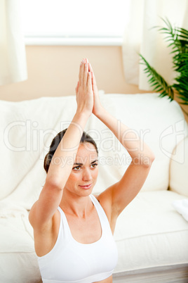 woman meditating in her living-room
