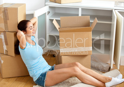 woman sitting on the floor after unpacking