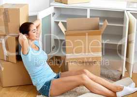 woman sitting on the floor after unpacking