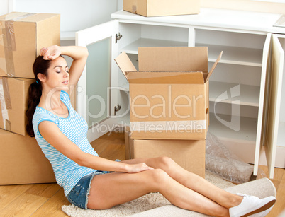 woman sitting on the floor after unpacking