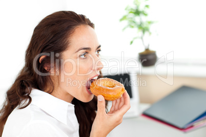 businesswoman eating a doughnut