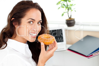 businesswoman eating a doughnut